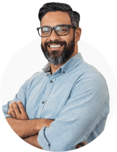A professionally dressed man, looking happy with his arms crossed and looking into the camera. This is on a white background.