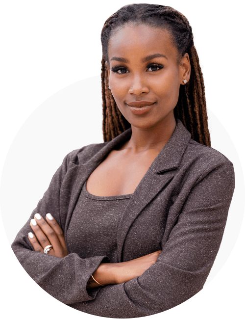 A professional looking woman in a brown blazer, with her arms crossed looking into the camera.