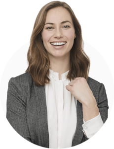 A professional looking woman in a blazer, smiling at the camera.