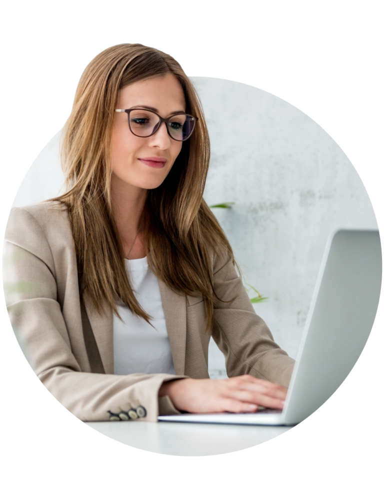 A professional woman on her laptop looking up something for her job.